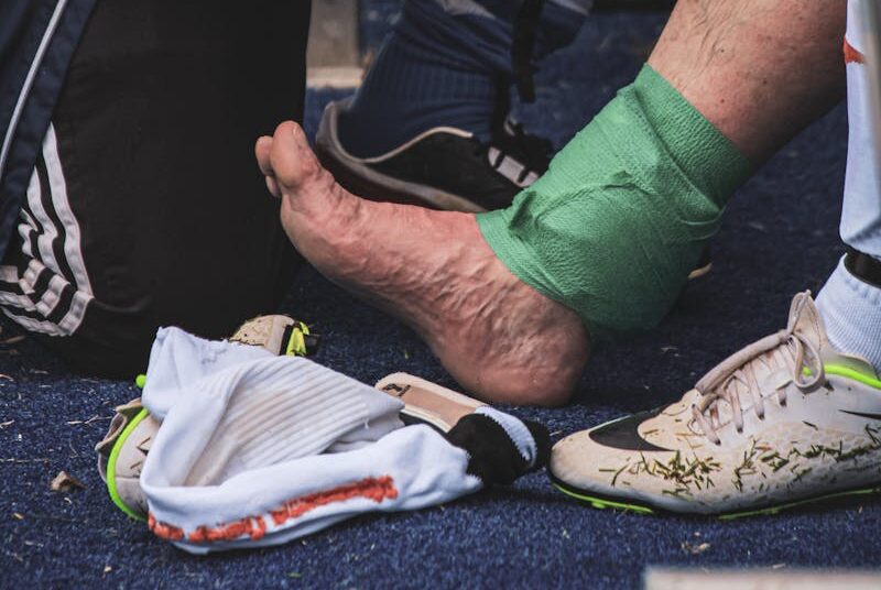 Man Helping a Player with the Injury During the Game